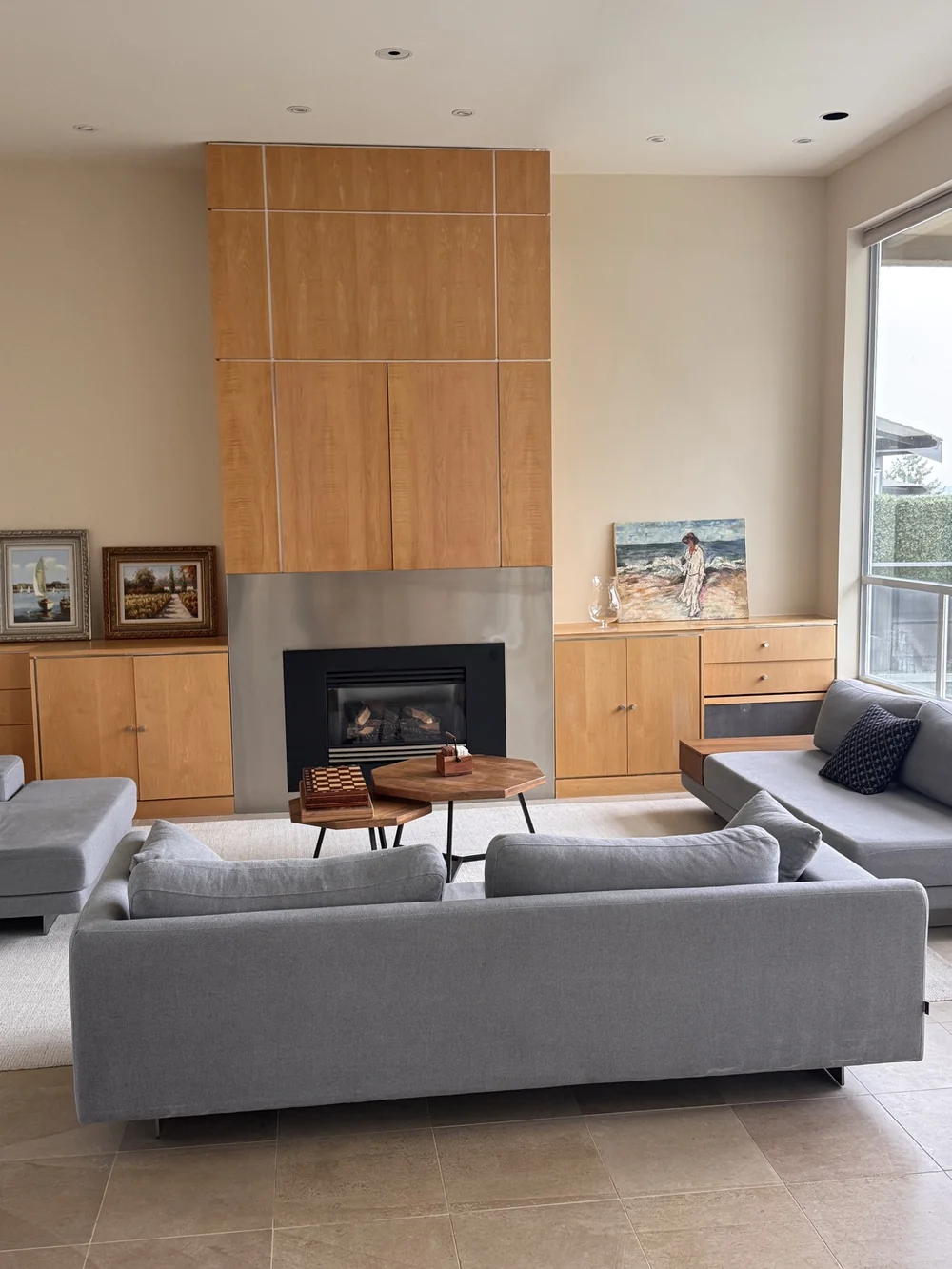 Living room with a wood-panel fireplace, freshly cleaned